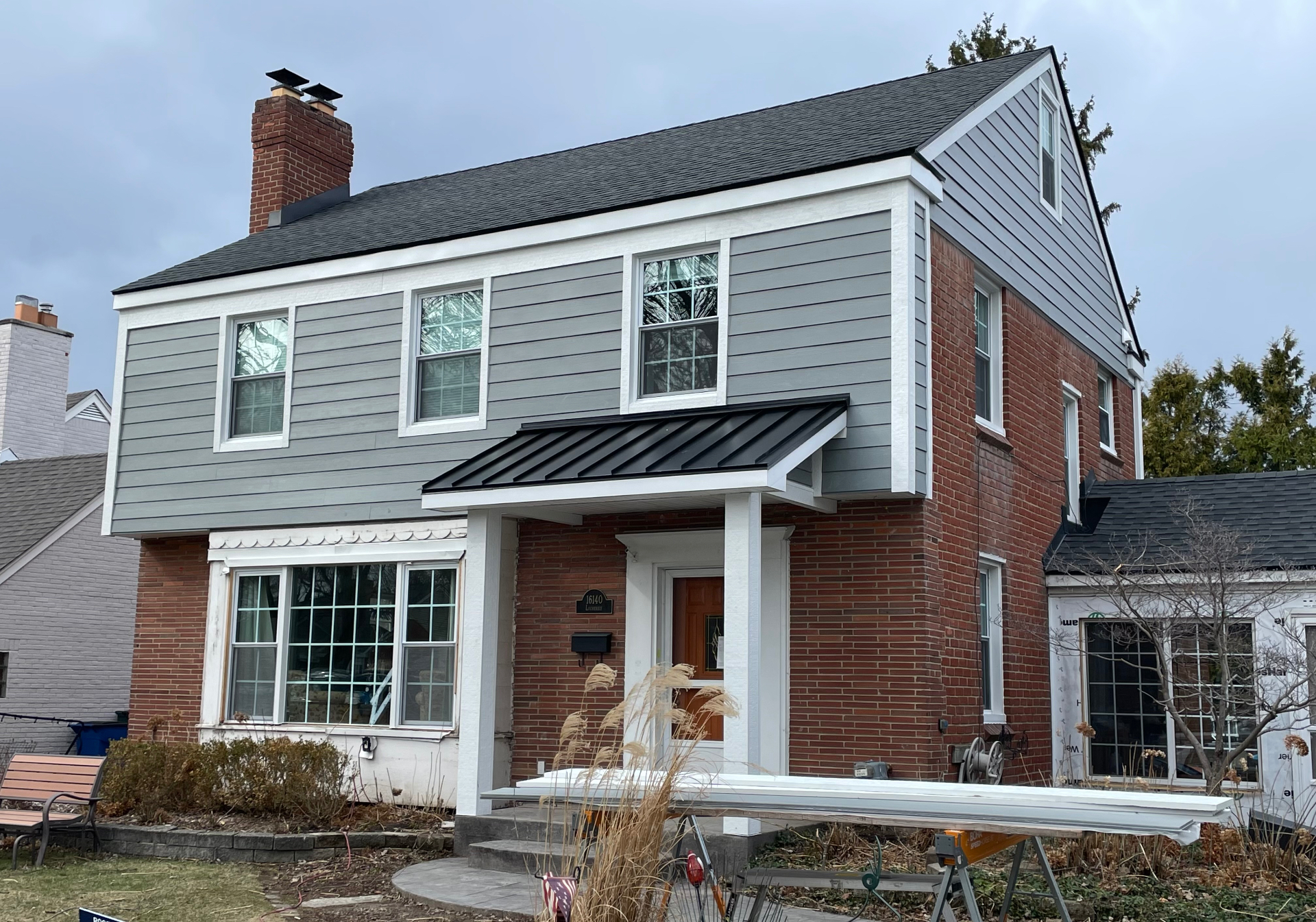 Brick Colonial — After (Hardie Siding & Standing Seam Porch)